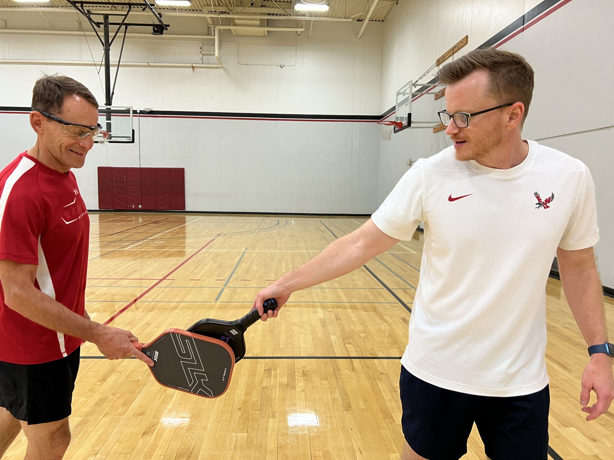 Dave Millet playing pickleball at EWU and congratulating an opponent.