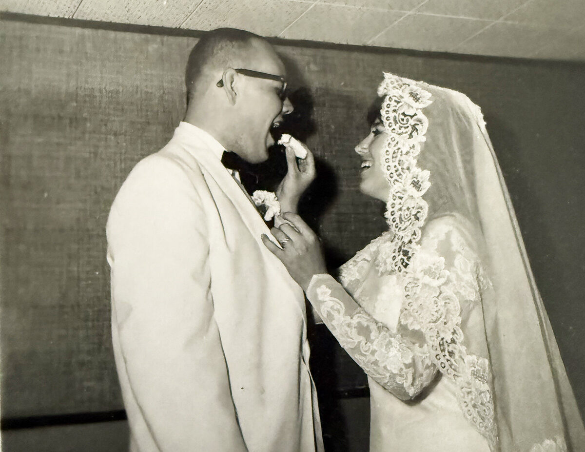 Linda and Bink's Wedding photo. Linda is feeding him cake.
