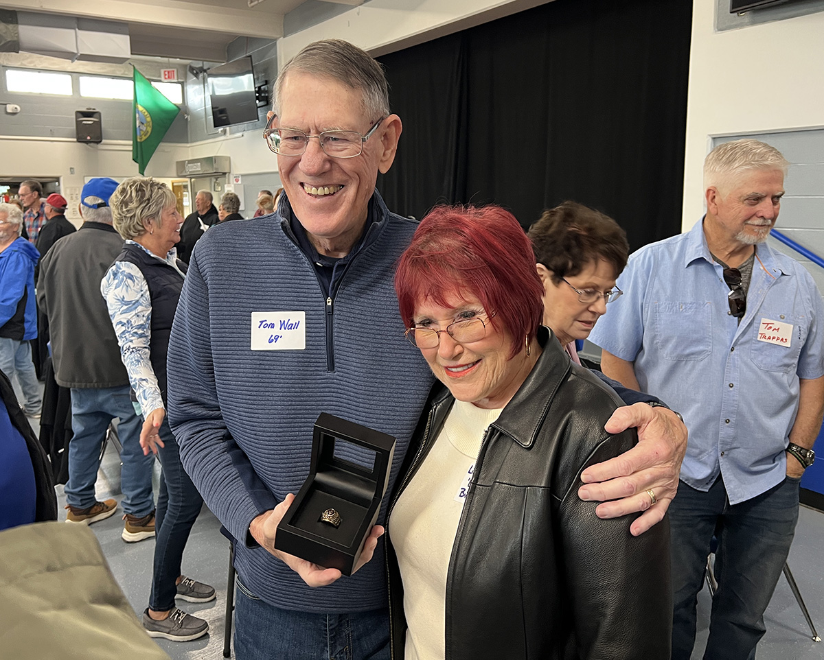 Photo of Bink's brother, Tom Wall, with Linda Wall-Sullivan holding the ring at the reunion.