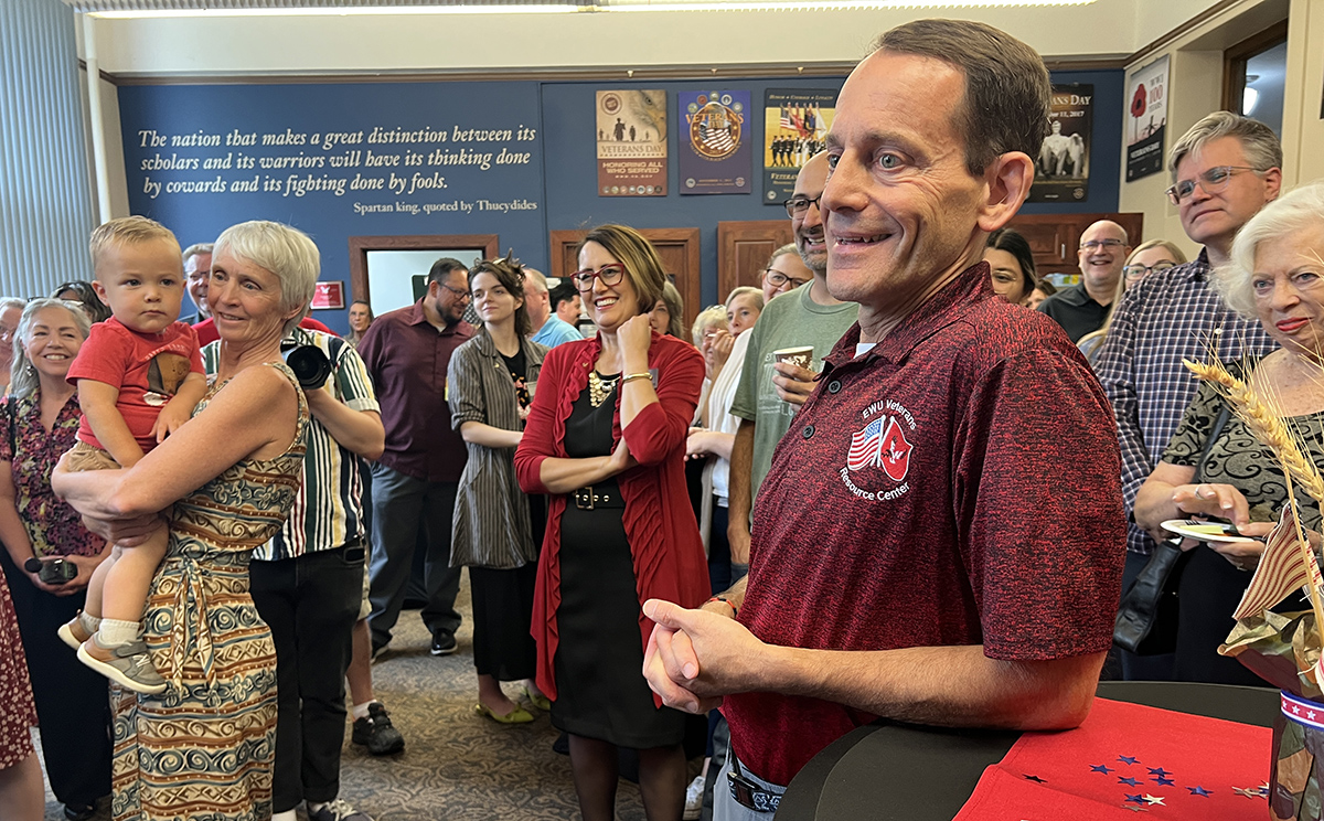 Dave Millet smiling with people in the background.