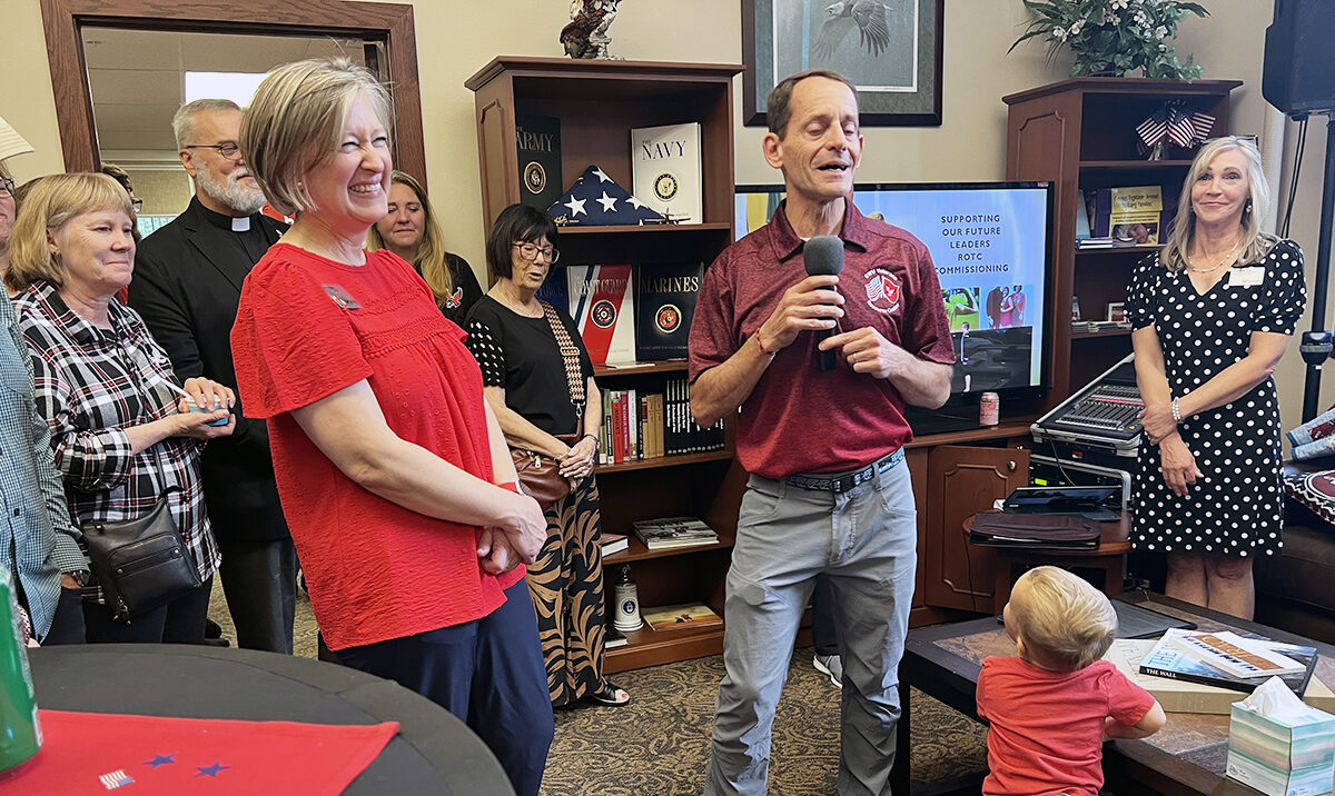 Dave Millet with the microphone makes Lena Tanguay laugh.