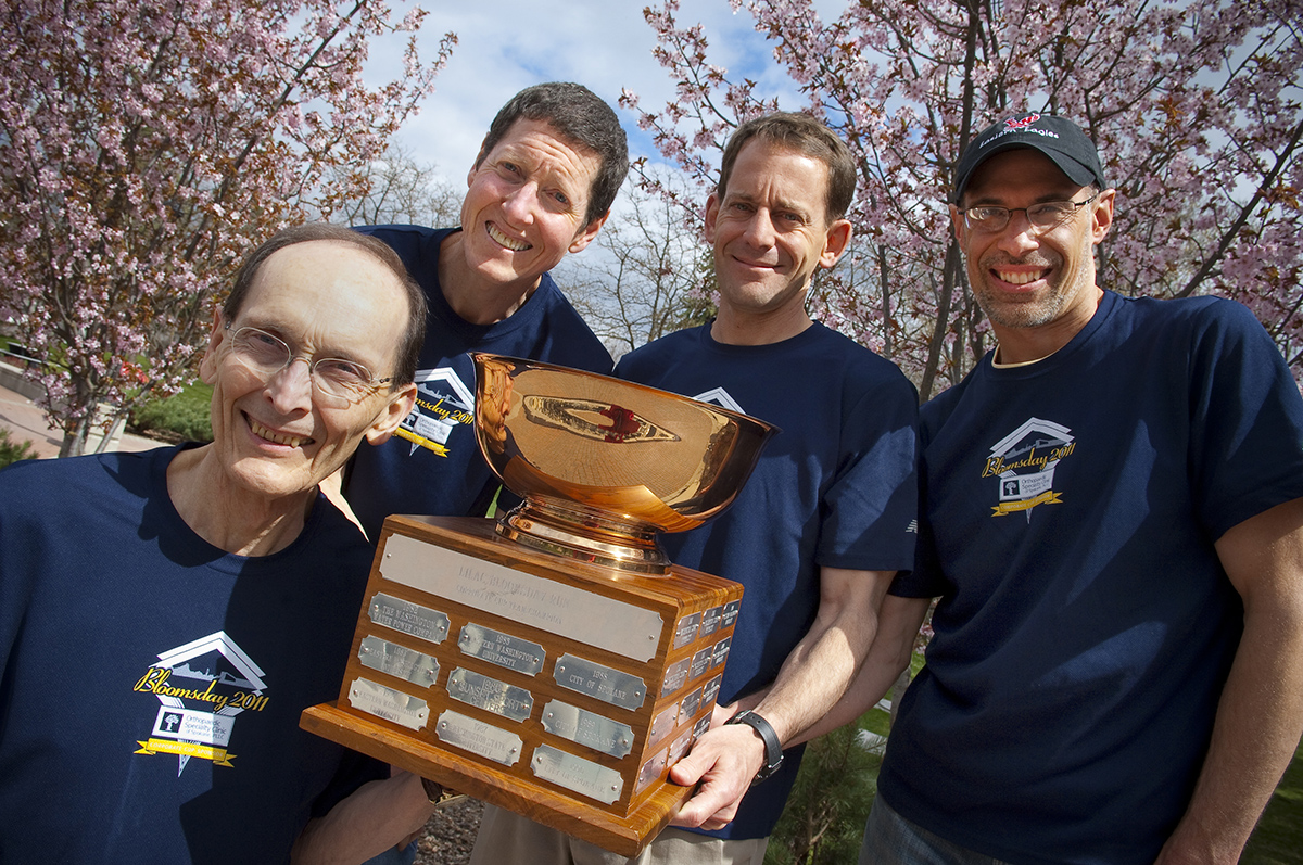 Millet is pictured holding the Bloomsday Corporate Cup with 3 other team members.