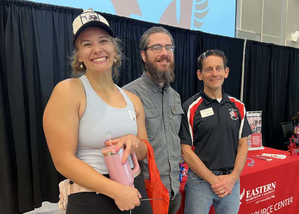 Dave Millet with two military veterans at a VRC booth during New Student Orientation.