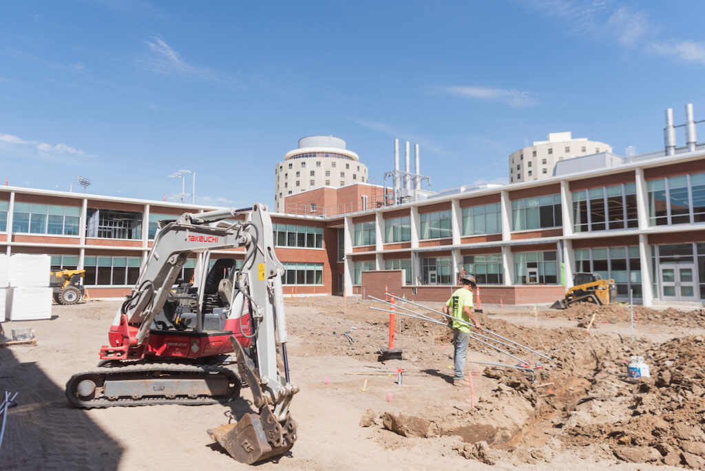 Photo of construction on interior courtyard of Science Building with a worker.