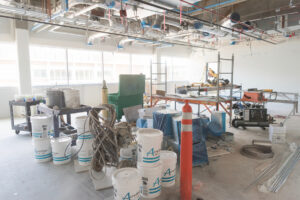 A room filled with buckets ladders and other construction supplies.
