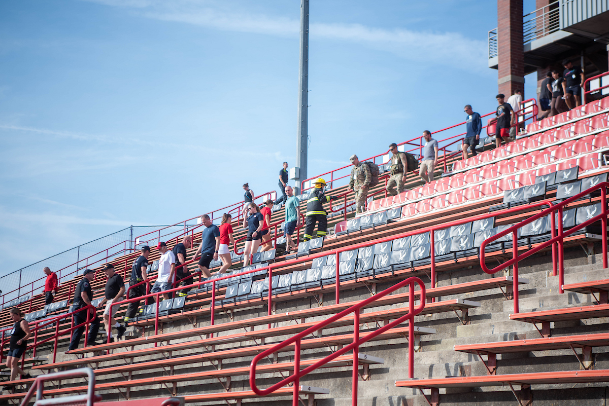 People climbing stairs at Roos Field.