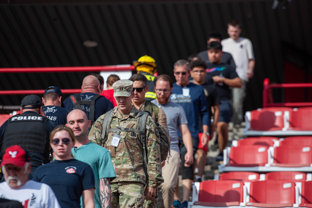 Photo of people climbing down the stairs in the stands at Roos Field.