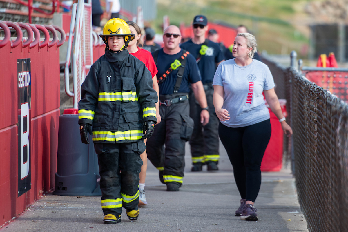 9-11 stair climb participants, including a female firefighter in full gear.