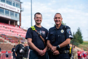 An EWU policeman and Cheney firefighter pose for a photo.