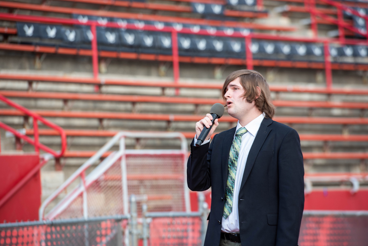 Student singing the national anthem.