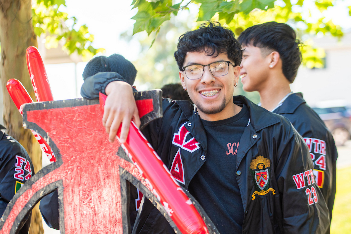 Fraternity member welcoming new students.