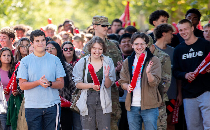 Students lined up and ready to pass through the pillars.