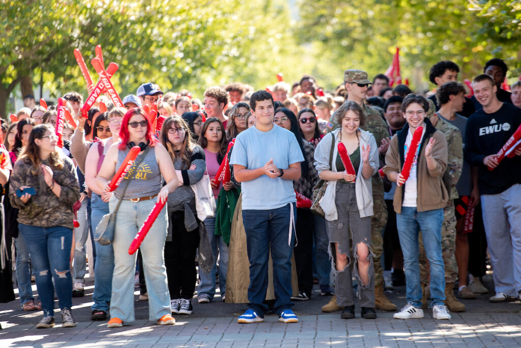 A crowd of students waiting to pass through the pillars.