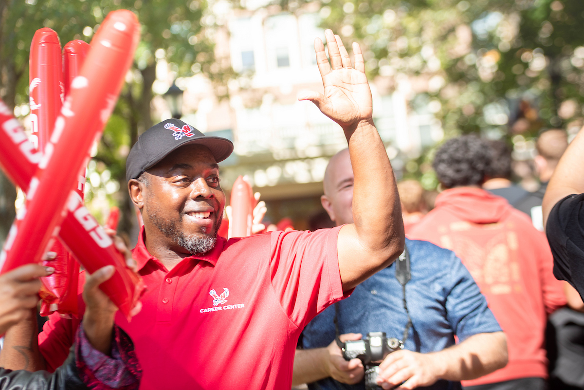 EWU employee waving to new students.