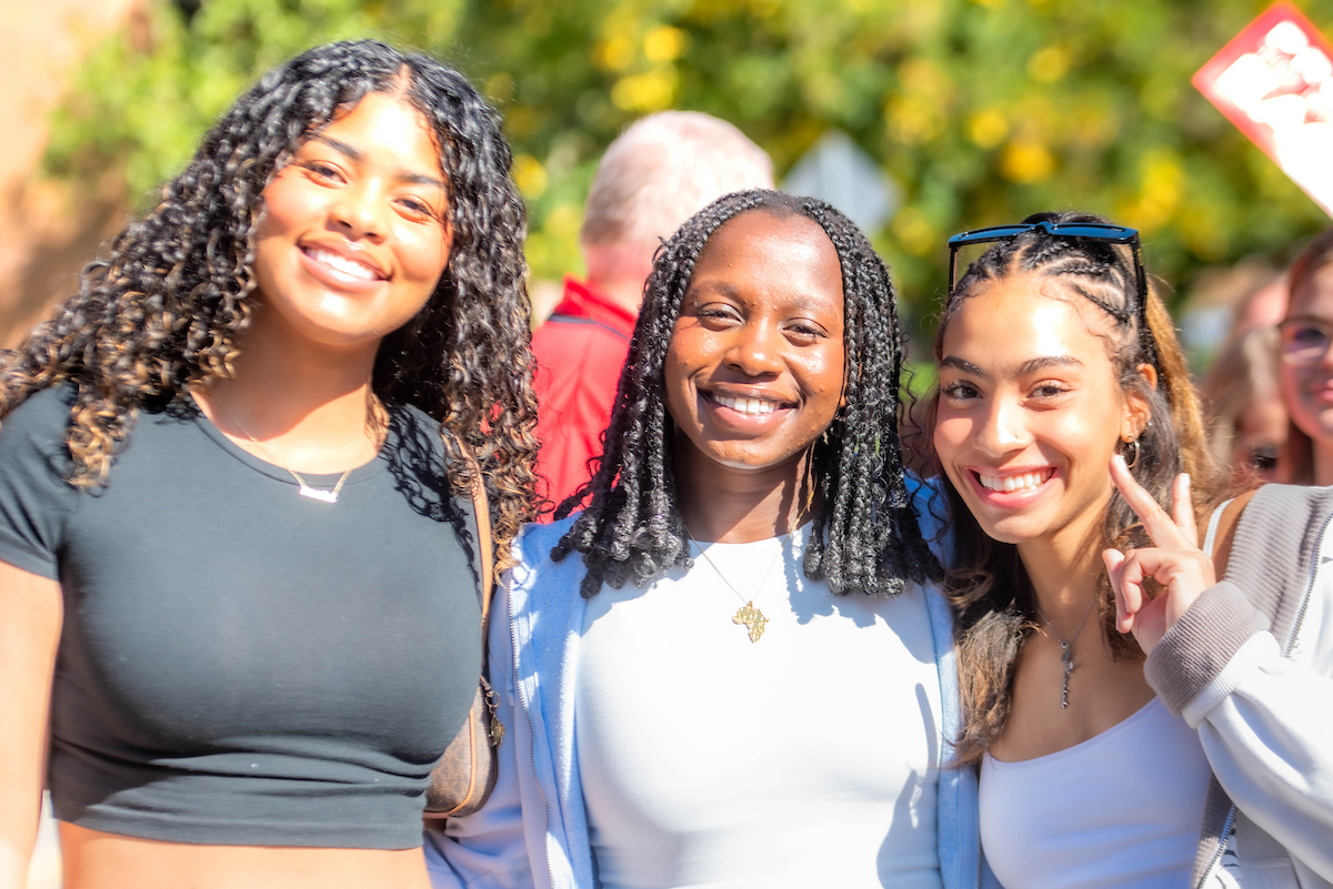 Three students smiling.
