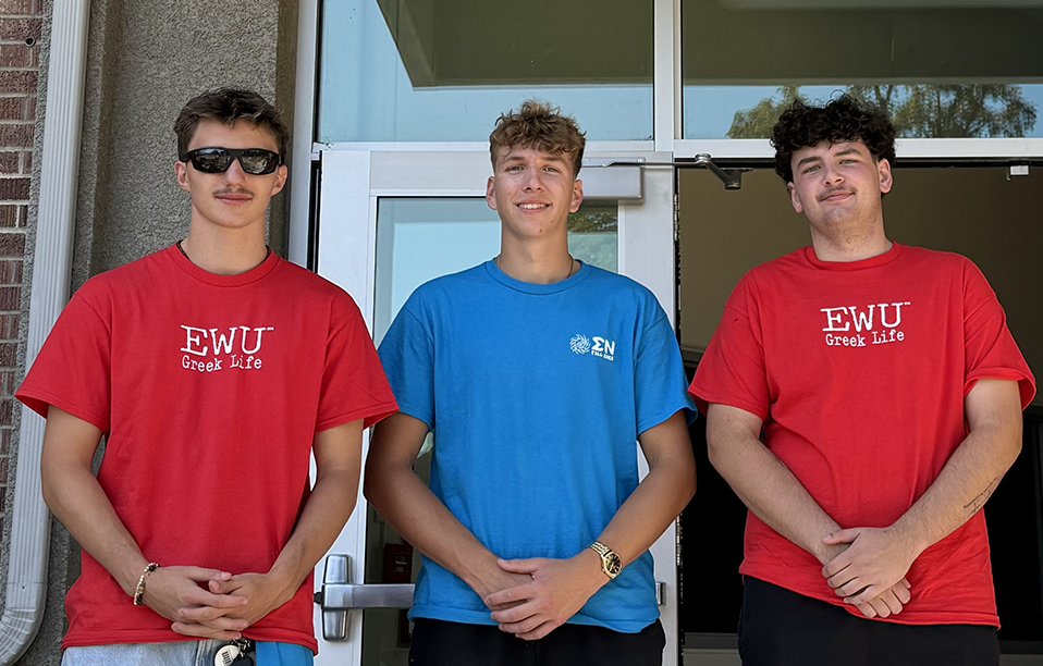 Three Greek Life volunteers in front of Anderson Hall.