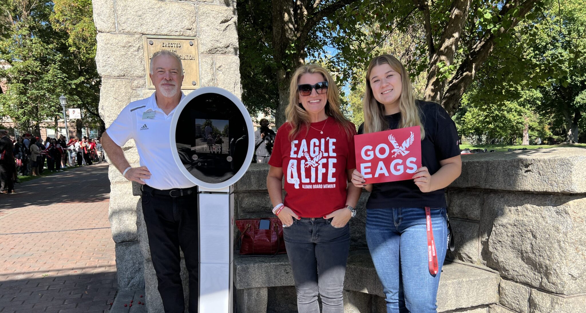 Alumni Association board members and assistant by the selfie station.