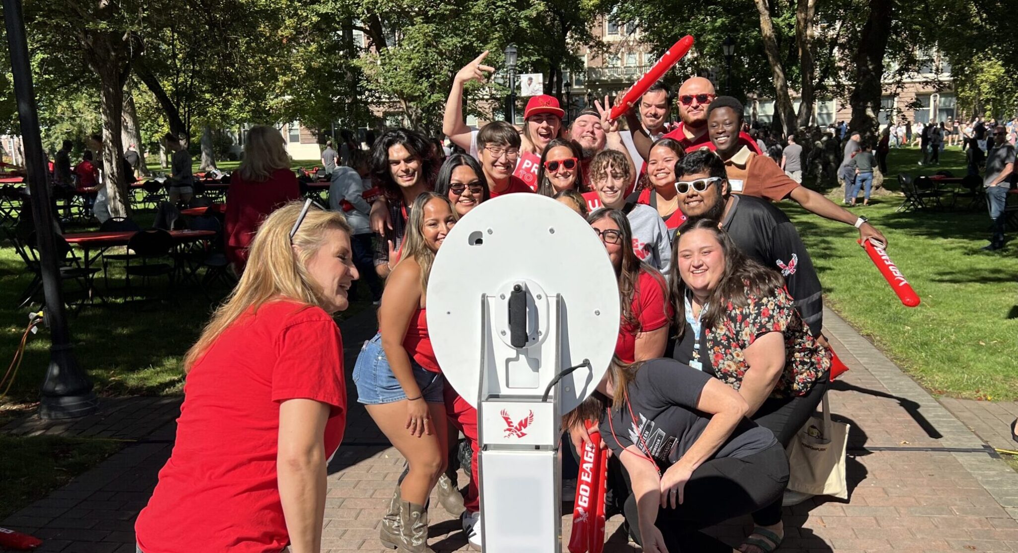 Volunteer helping group get a selfie at the selfie station.
