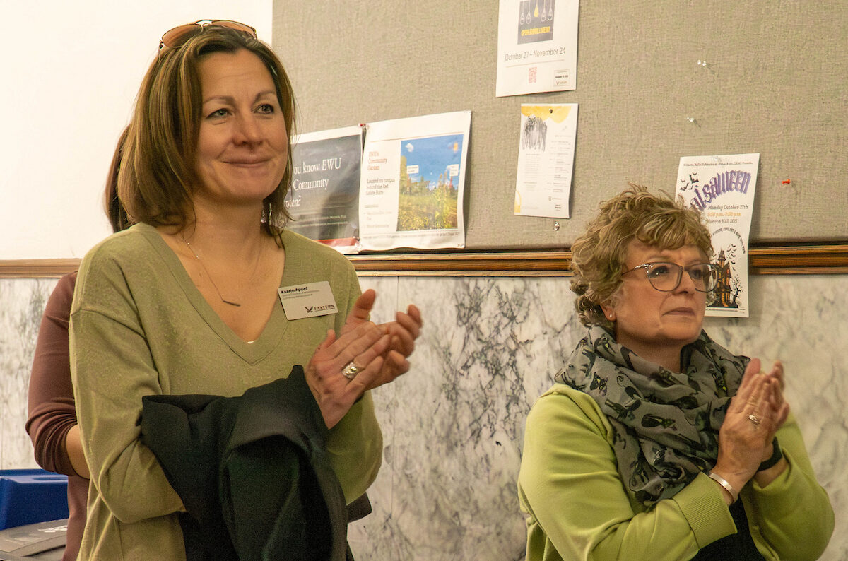 Two staff members clapping.