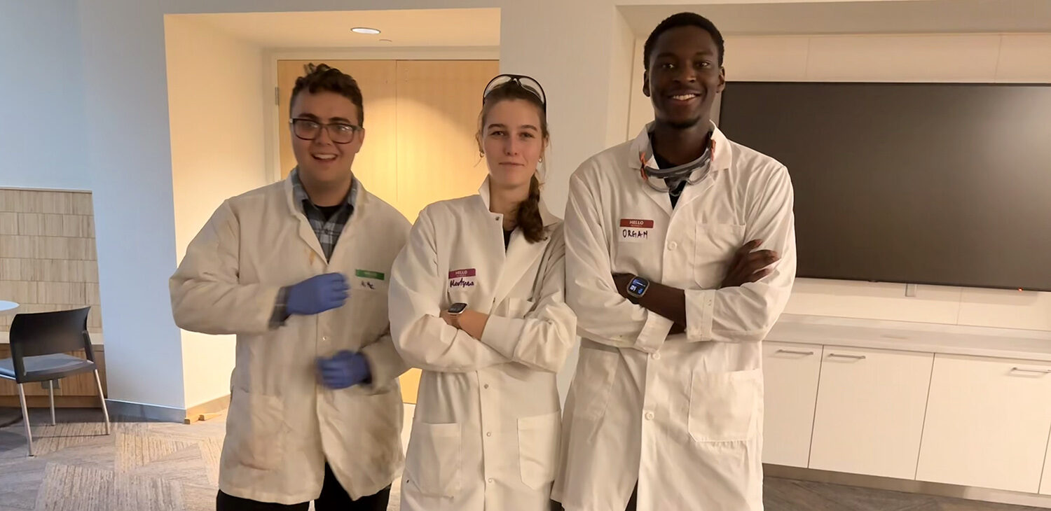 Three students in lab coats.