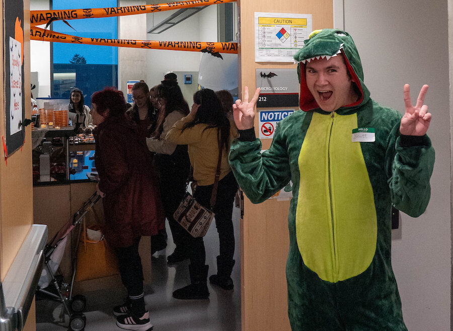 Student volunteer dressed as a dinosauer.