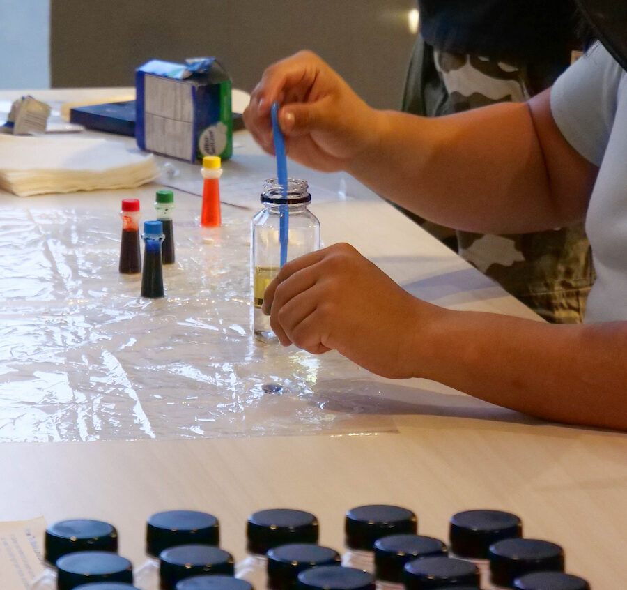 Arm doing an experiment with bottles nearby.