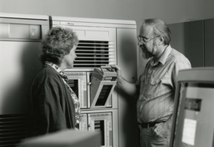 Steve Simmons, professor emeritus, computer science, and Linda Kieffer, vice provost, with an early VAX system, installed in the 1990s.