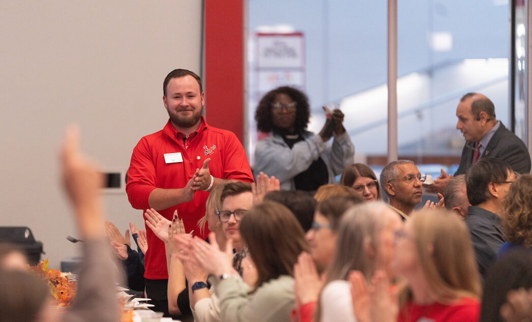 Riley Baxter receiving applause for years of service.