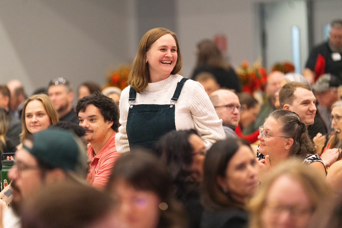 Employee standing for years of service applause.