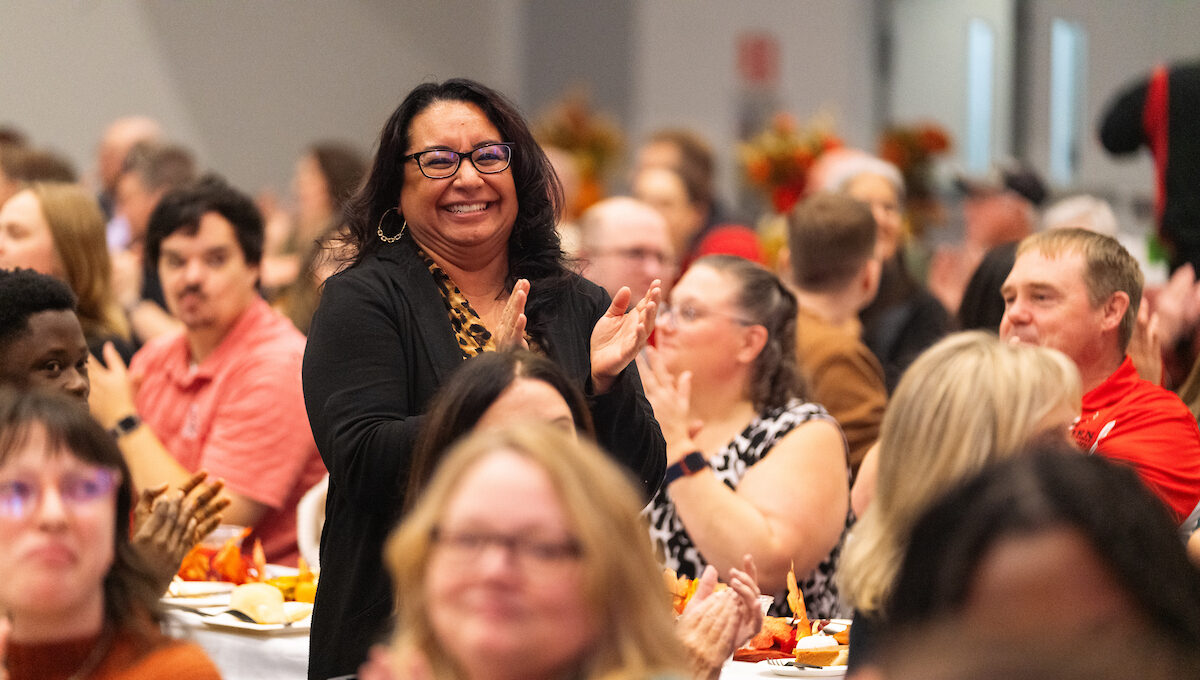 Maria Reyna standing and getting recognized.