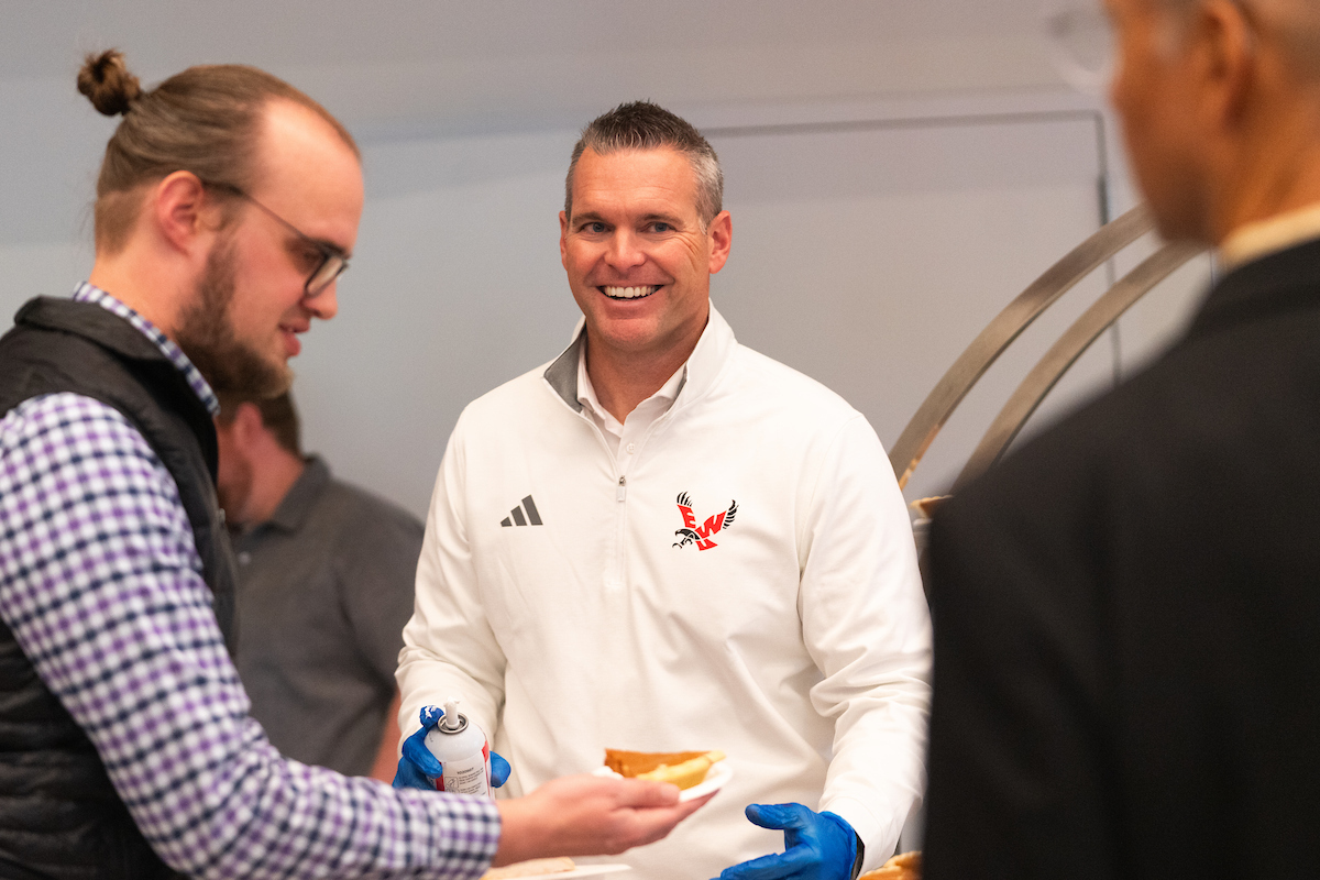 Athletics director Tim Collins distributing pie
