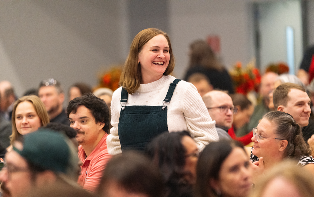 Photo of employee standing to be recognized.