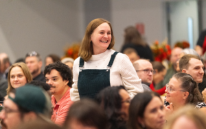Photo of employee standing to be recognized.