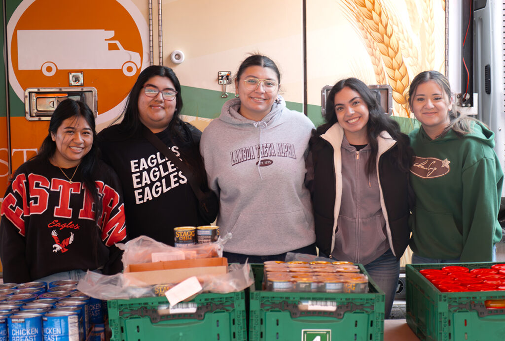 Five student volunteers pose for a photo.
