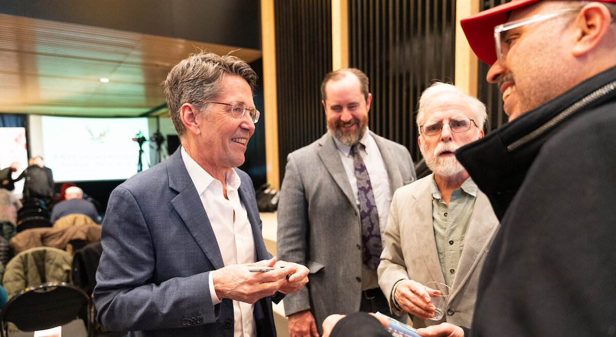Jess Walter signing books for attendees at the Catalyst event.