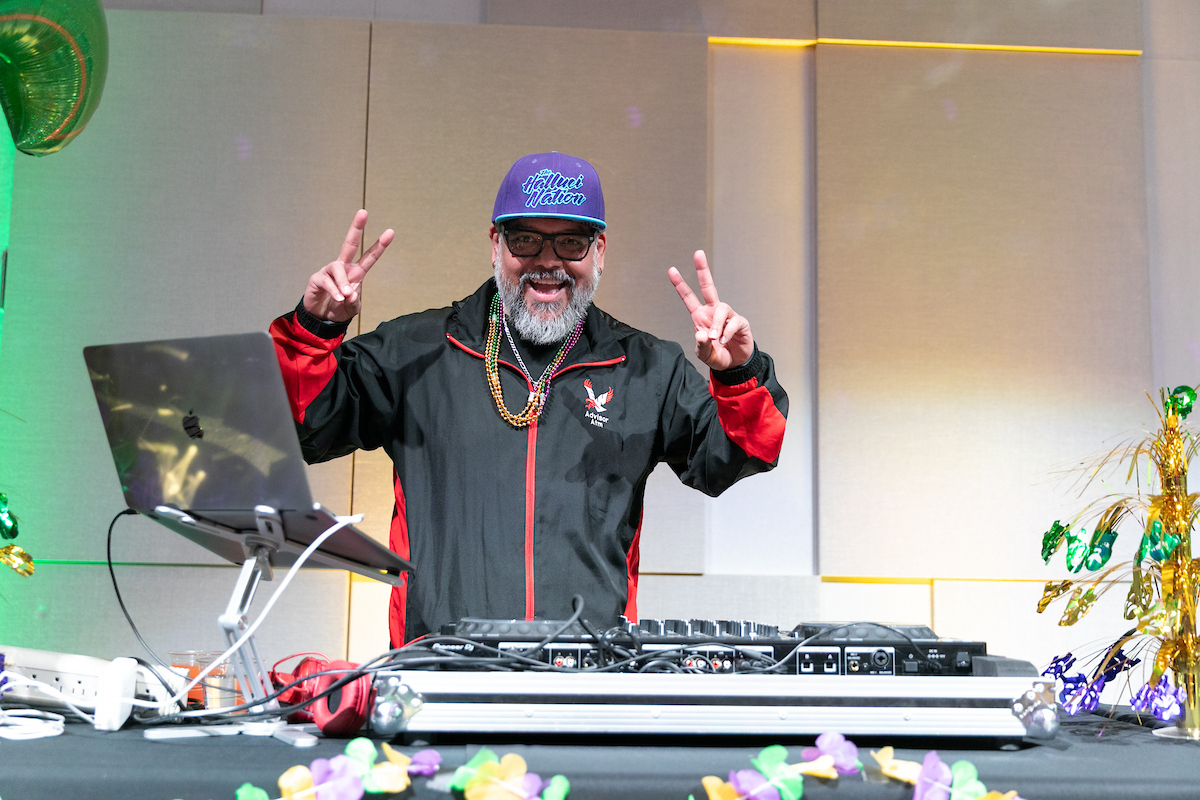 The DJ for the evening flashing peace signs.