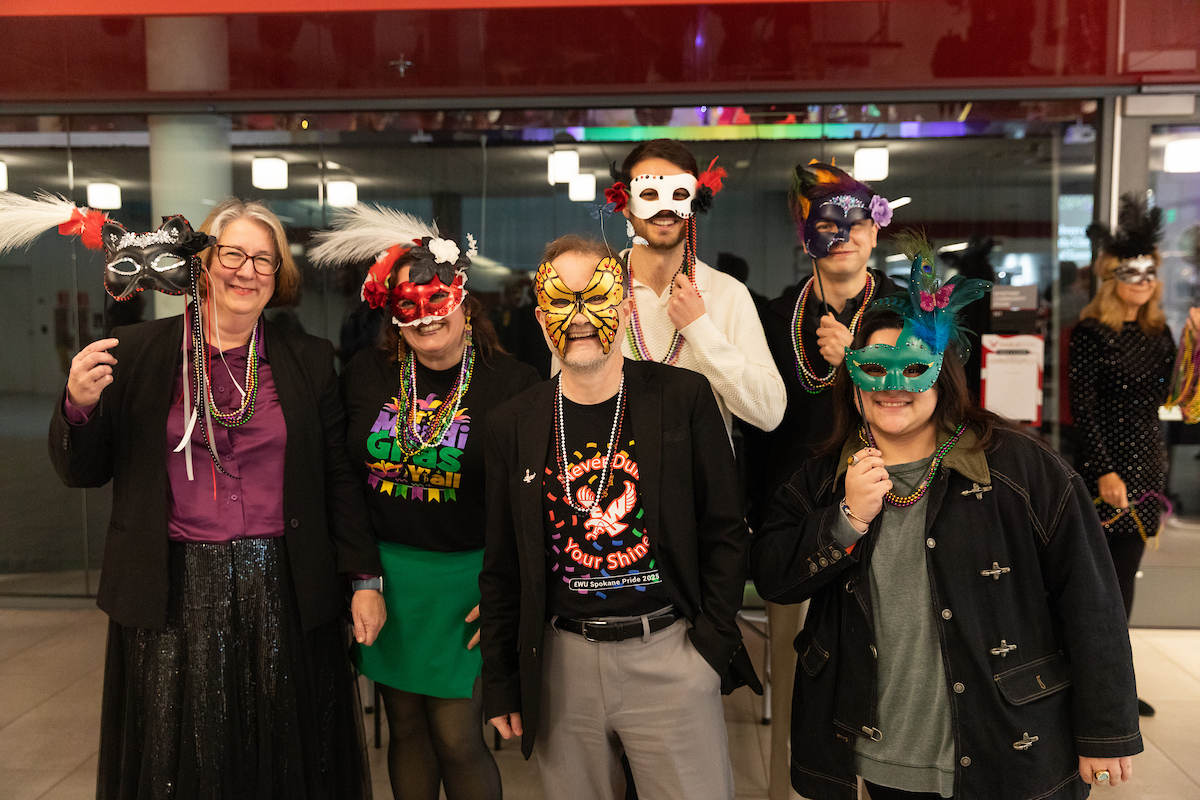 A team from CAHSS wearing beads and masks poses for a photo.