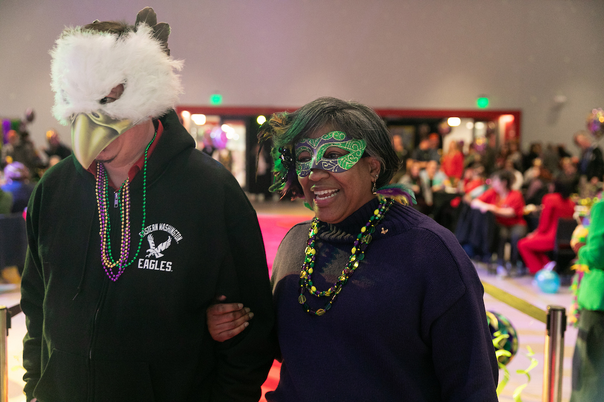 A masked Dawn Kinnunen-Lewis with an employee wearing a bird mask.