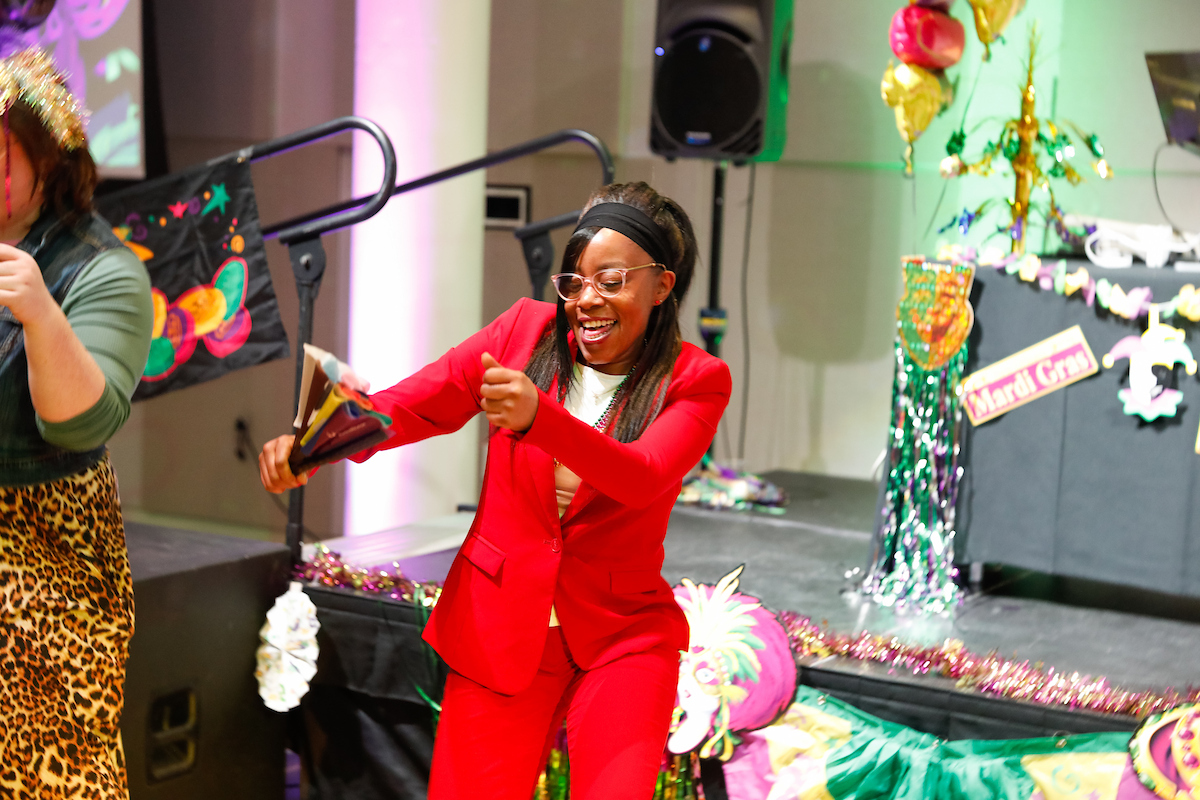 Employee hosting and dancing.