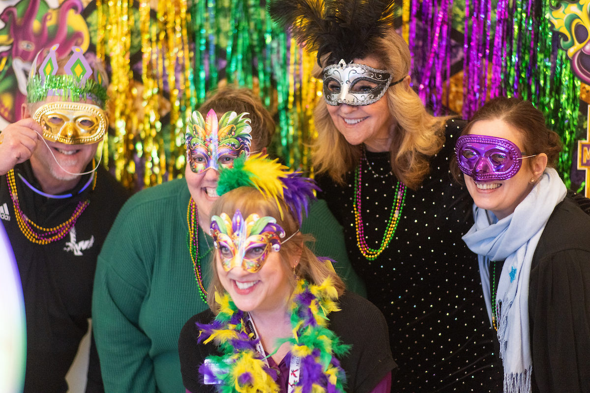 President McMahan's team poses for a photo in their masks.