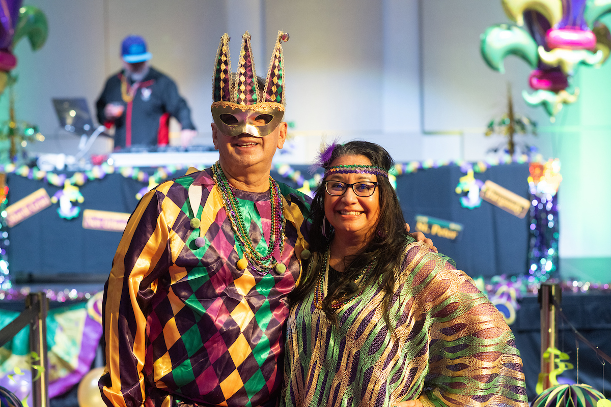 Cesar Portilla and Maria Reyna decked out in Mardi Gras costumes.