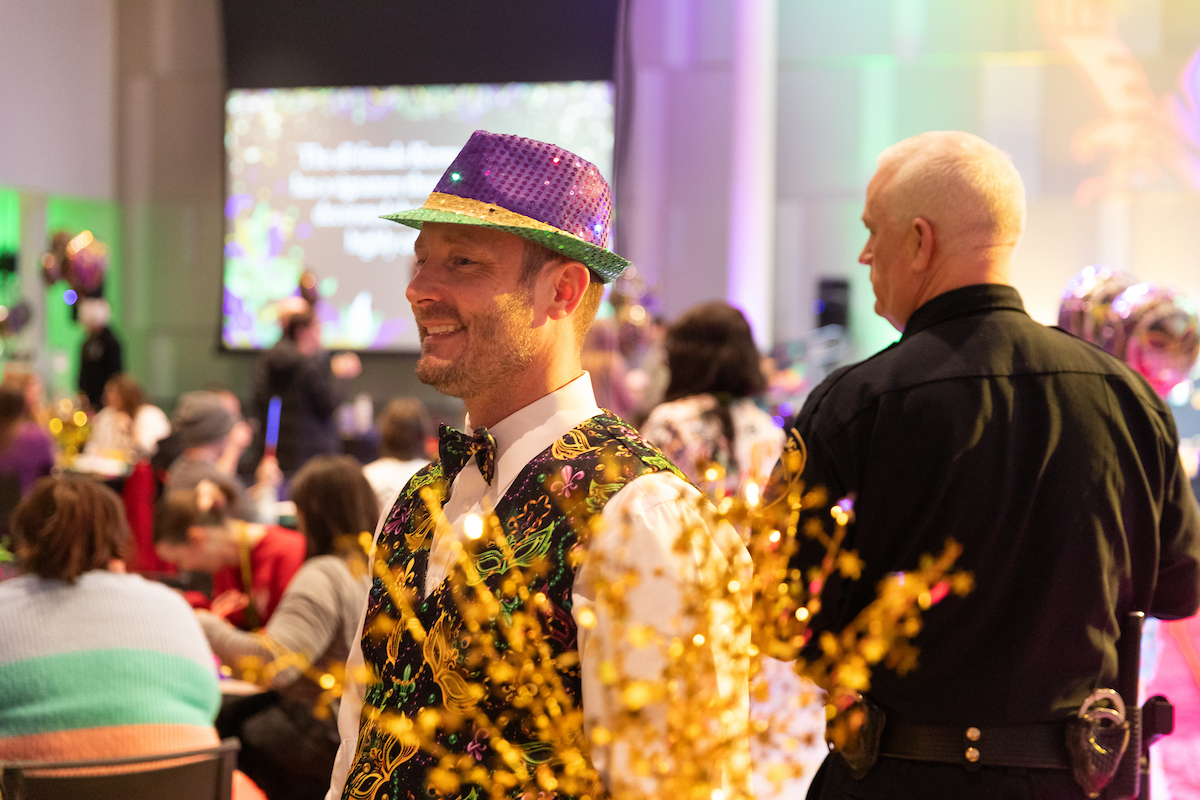 Employee wearing colorful hat.