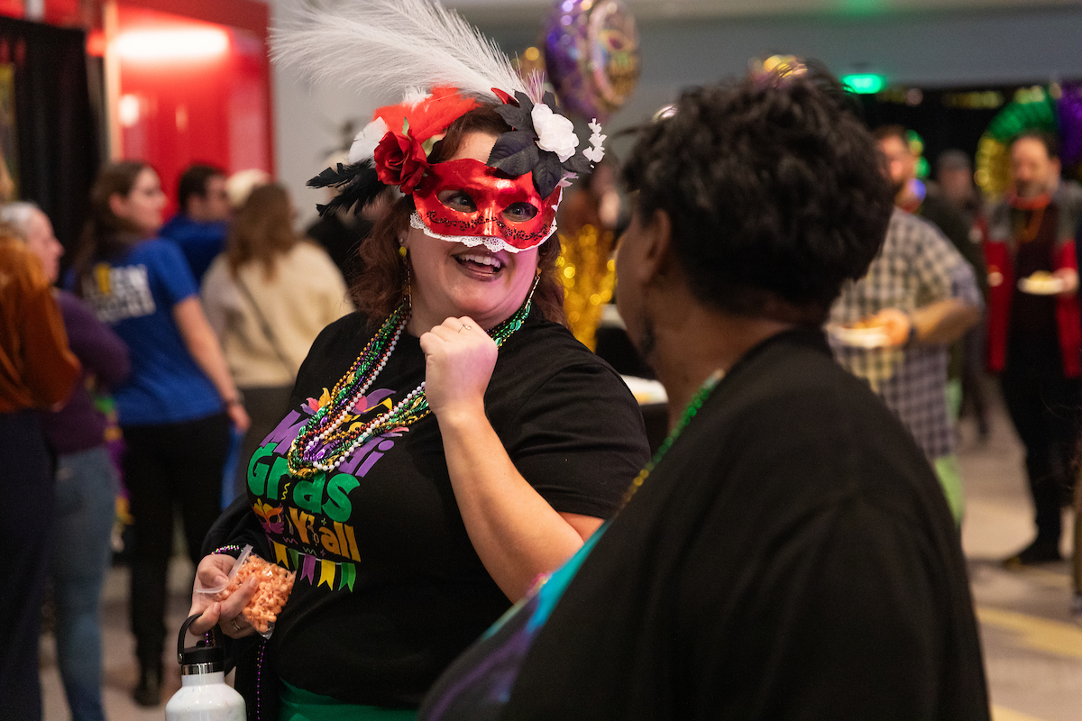 Employee wearing a mask and talking.