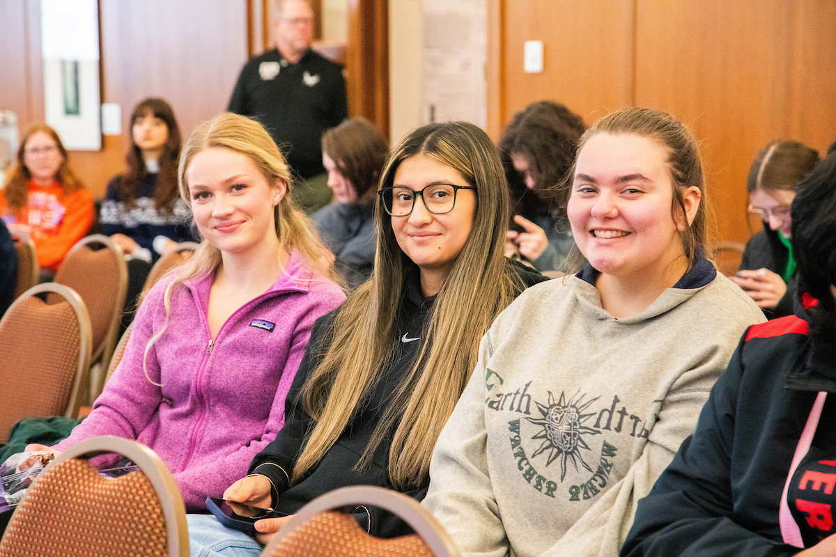 Three students listening to Jess Walter.