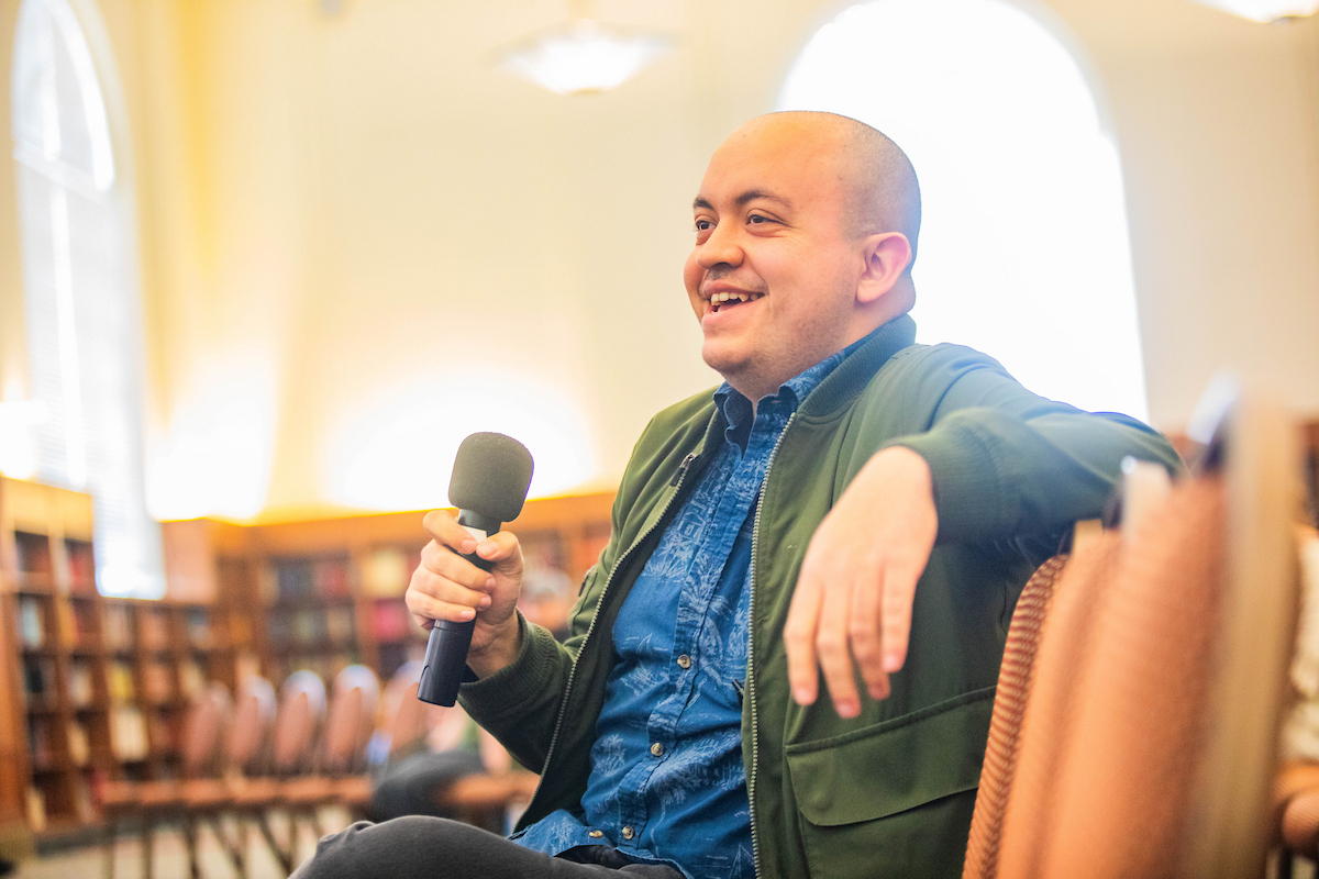 Man asking question with a microphone.