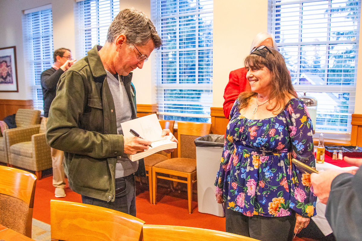 Jess Walter signing a book.