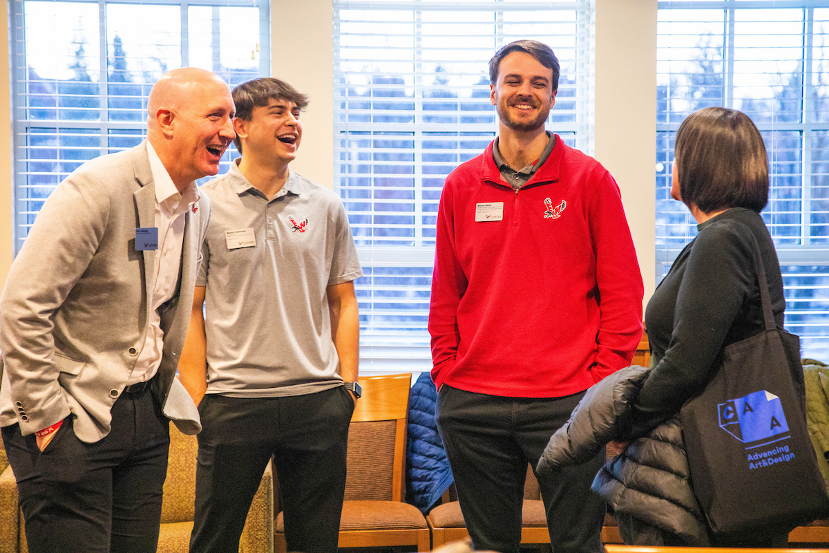 Eric Limberg and other employees laughing.