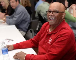 Vic Wallace at a meeting wearing an Eastern Eagle polo,