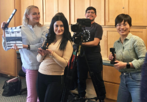Four Barton English School students posing with video equipment as they helped with interviews for the course.