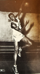 Fletcher Frazier jumping, wearing his basketball uniform.